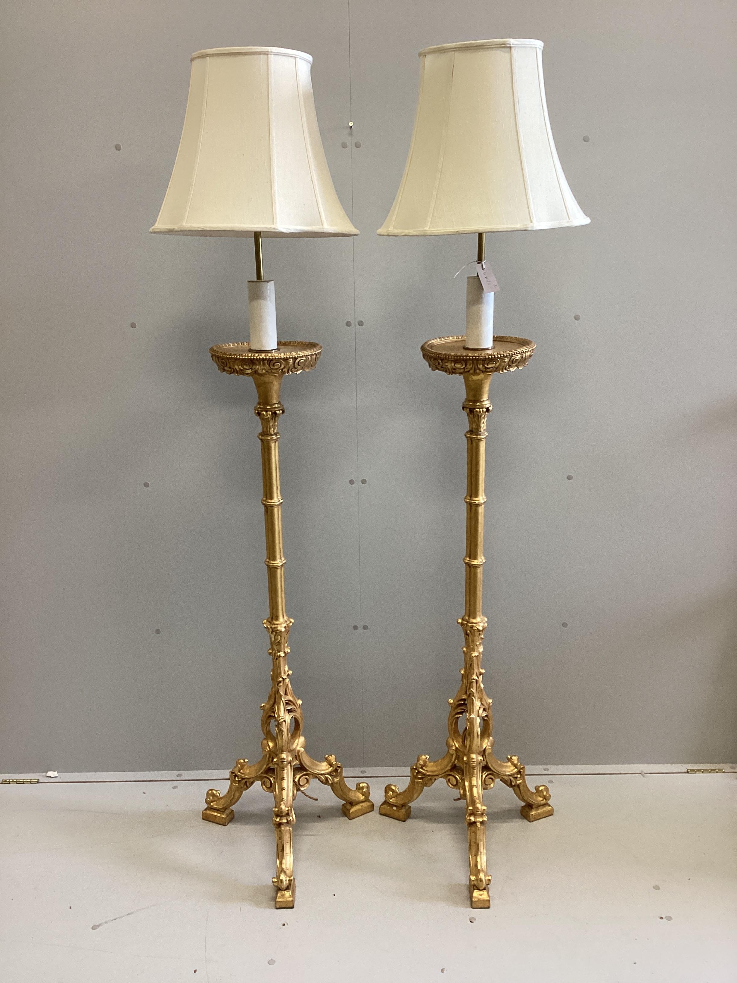 A pair of 18th century style carved gilt cluster column tripod standard lamps, height including shades 188cm